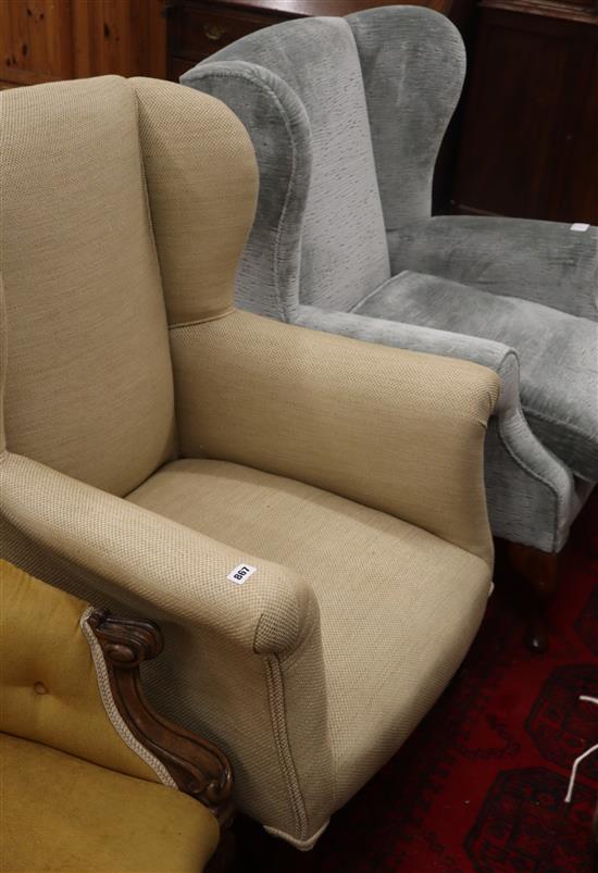 Two upholstered wing armchairs